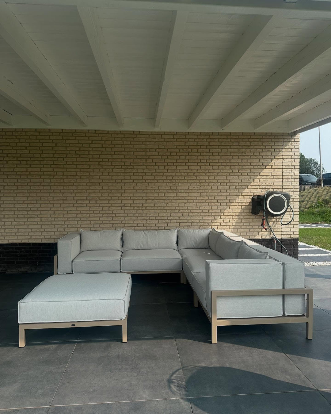 FALAIN loungeset onder een overkapping bij lichte gevel